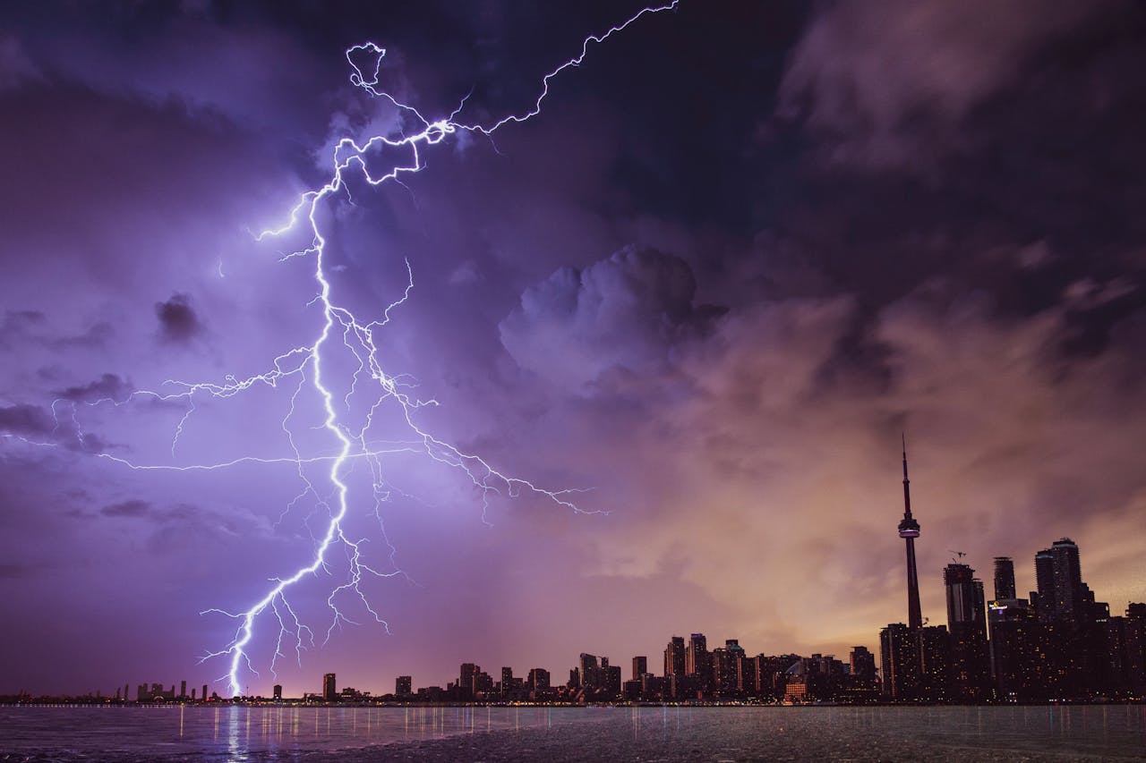 about-us-01 A striking lightning bolt illuminates the Toronto skyline against a dramatic stormy sky.