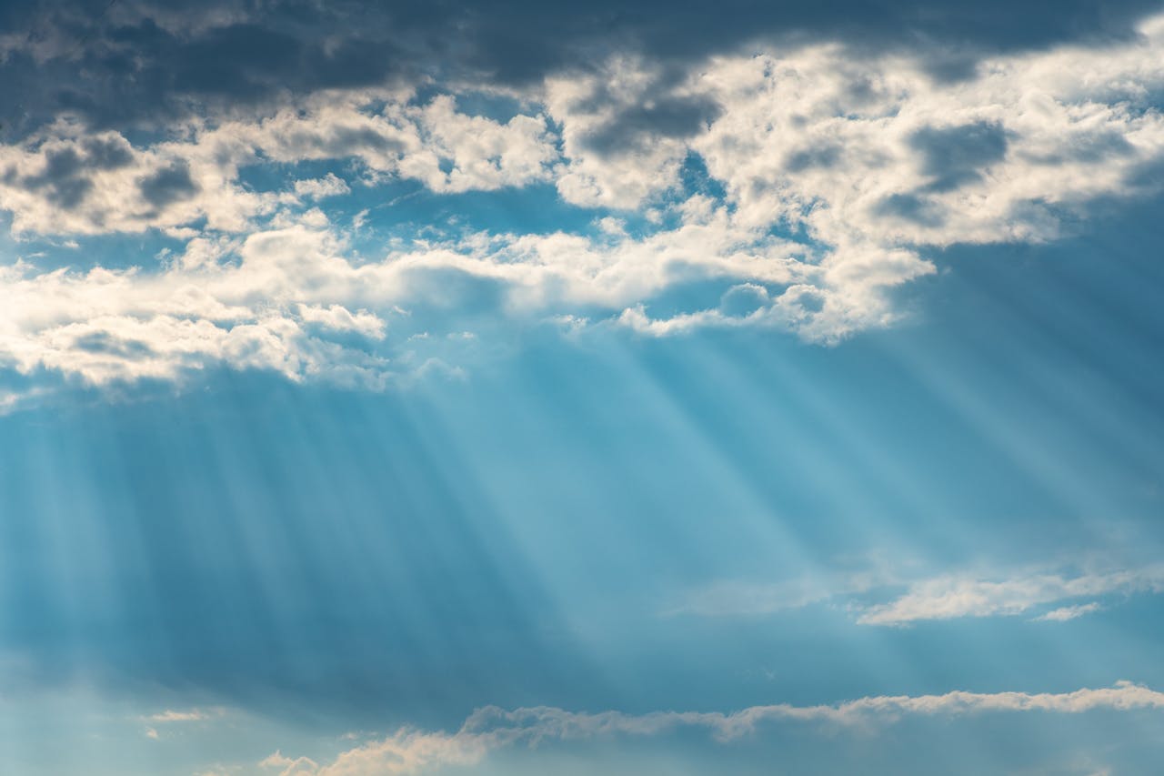 heros-img Vibrant sunrays pierce through a cloudy sky, creating a dramatic and dreamy cloudscape.